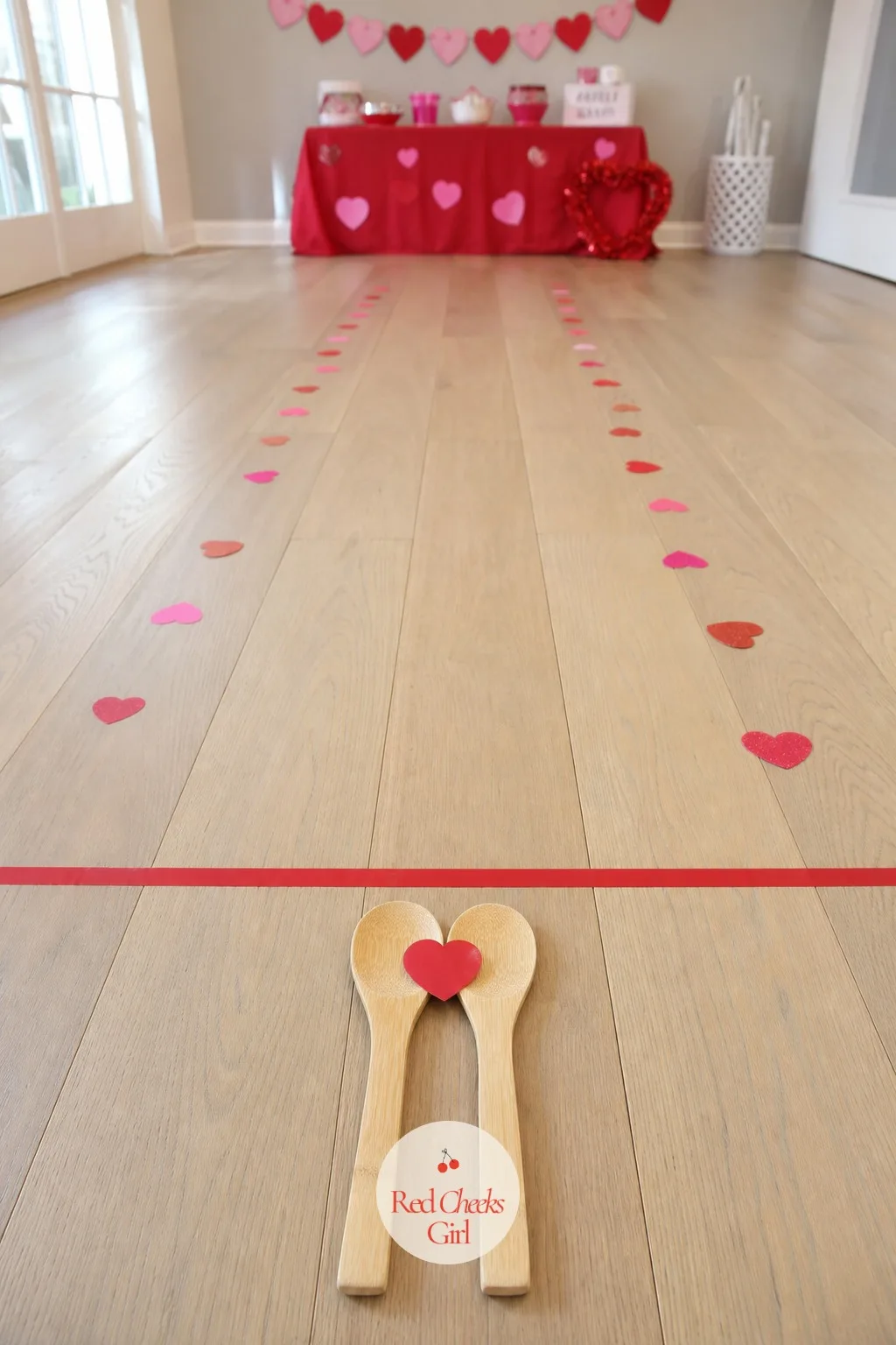 Hand-in-Hand Heart Spoon Relay — Each couple holds hands with one free hand each, leaving one spoon between them to balance a small plastic heart across a