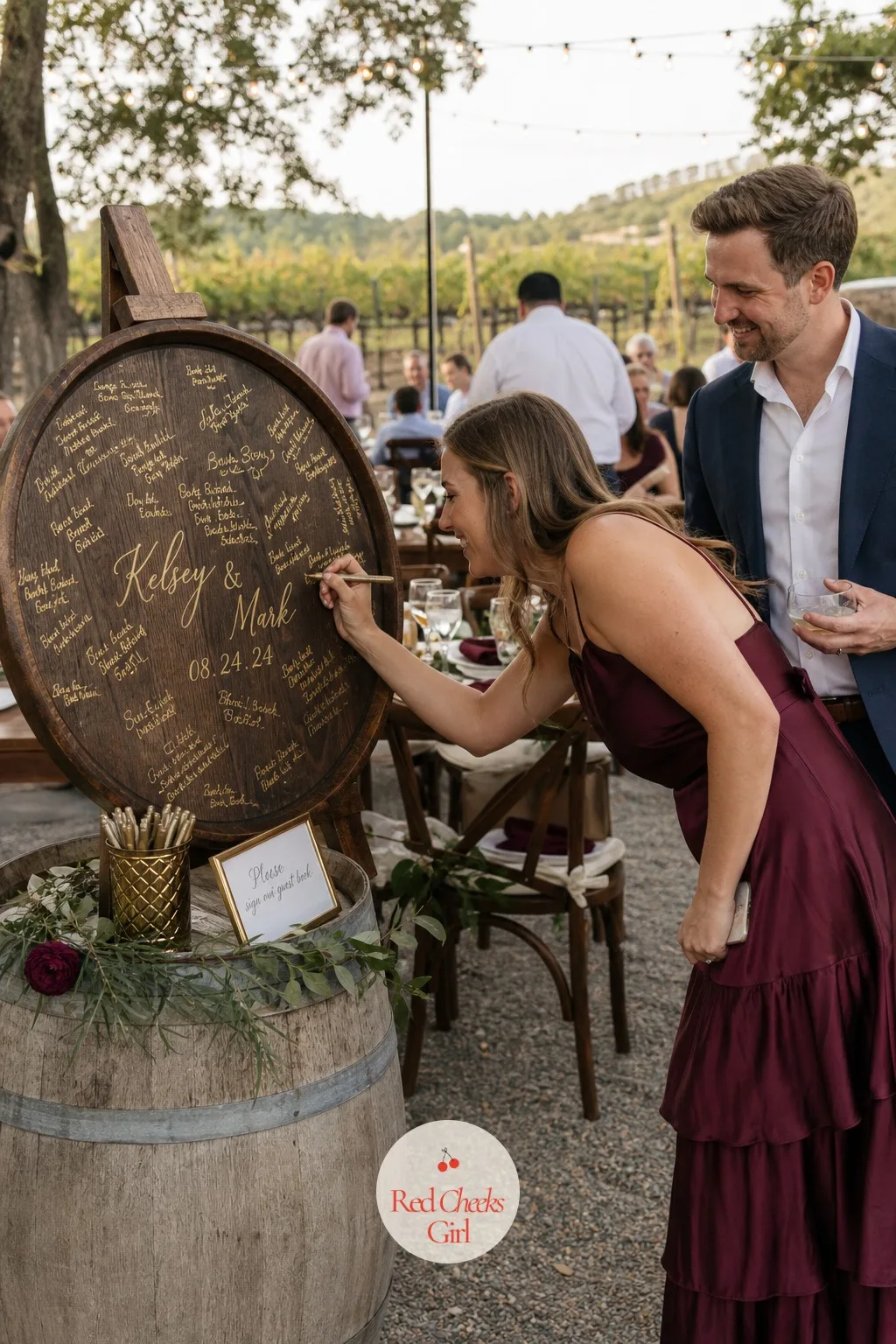 The Wine Barrel Lid Guest Book — Instead of signing a book, guests pick up a gold paint pen and sign directly onto a round barrel lid propped on a short stand