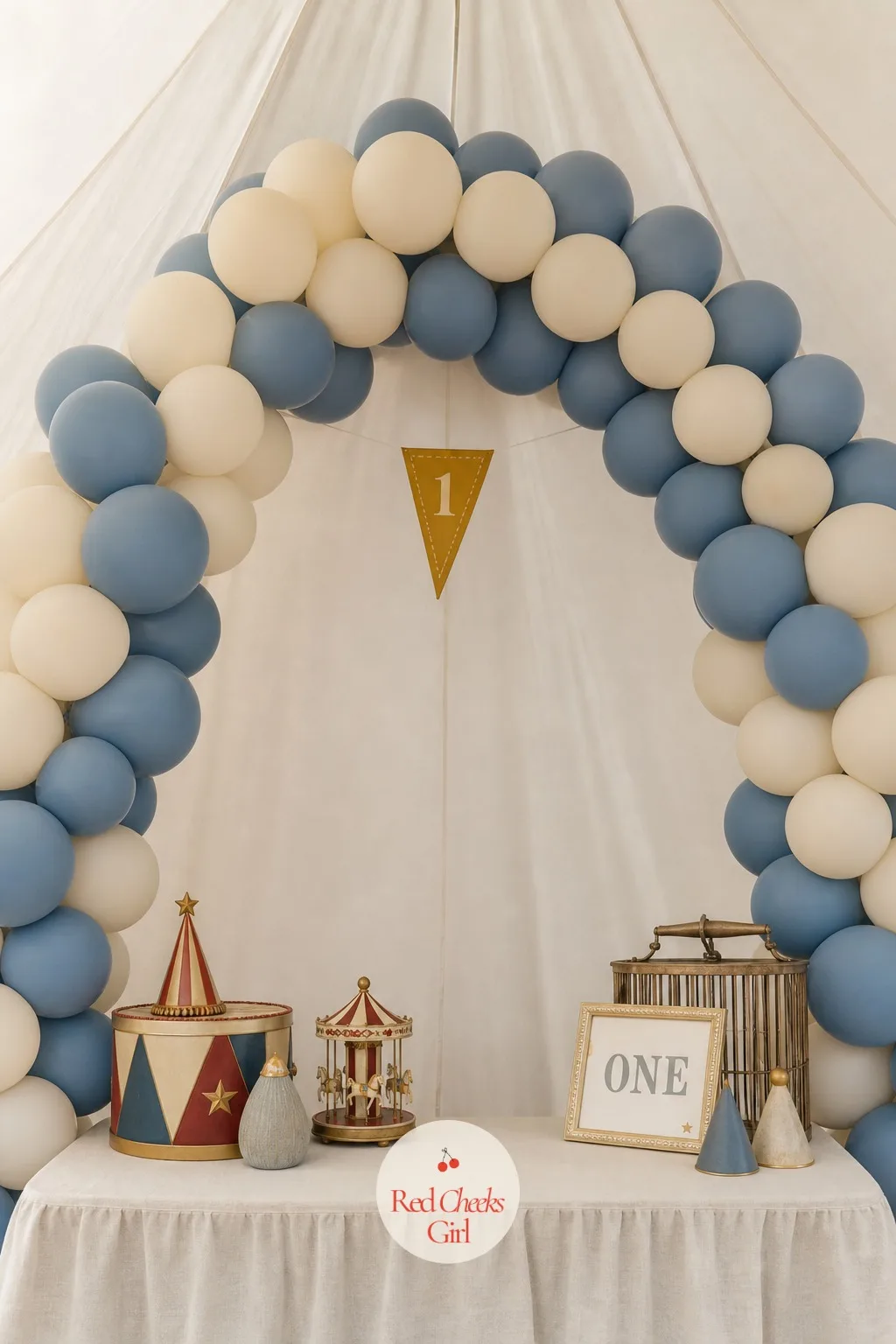 Cream and Dusty Blue Big Top Arch — A rainbow balloon arch shouts carnival, which is exactly what this is not trying to be. Vintage circus first birthday