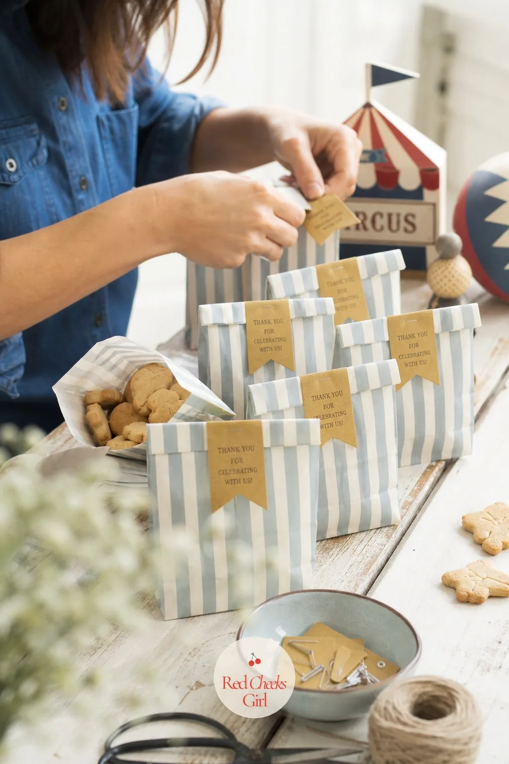 Cream and Dusty Blue Striped Treat Bags — Small bags in cream and dusty blue stripes, tops folded over and stapled flat with a mustard paper tag tucked under