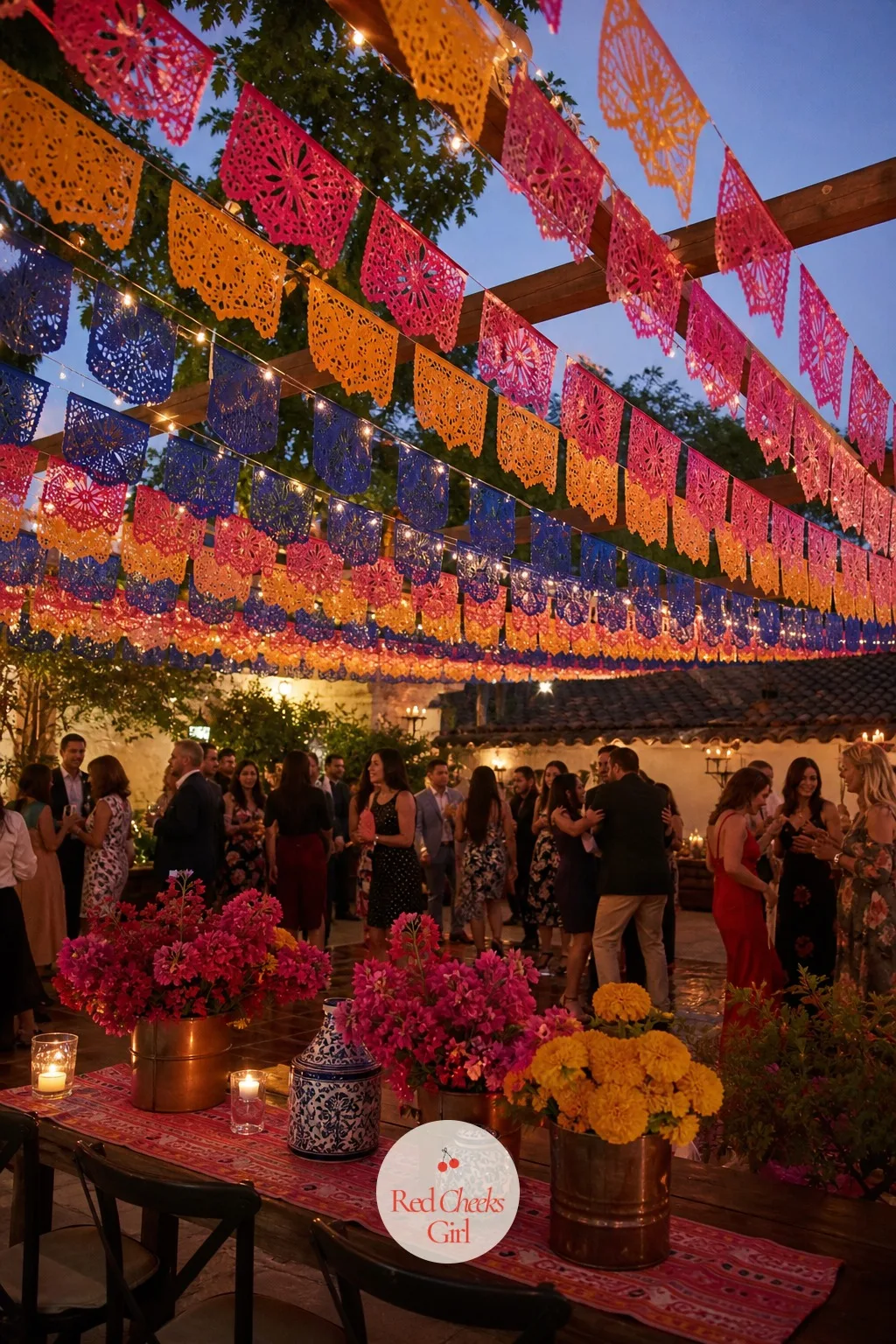 The Papel Picado Canopy Over the Dance Floor — She will worry paper banners read as piñata party rather than wedding, right up until she sees them cut in one