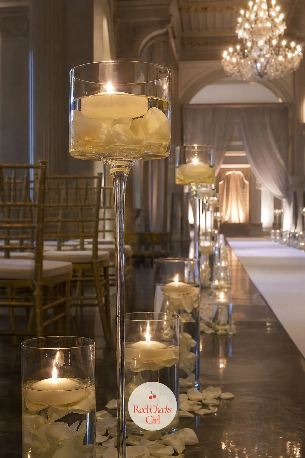 Floating Candles In Glass Bowls On Pedestals — A row of short hurricanes can disappear in a tall ballroom, where the ceiling pulls the eye up and away from