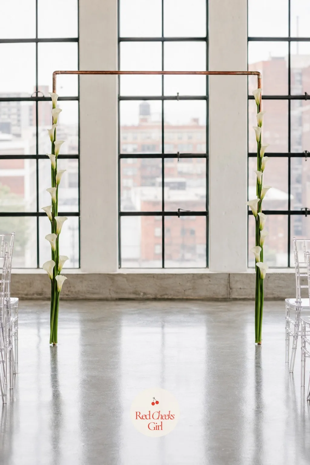 Calla Lily Minimalist Line Arch — Some couples want the opposite of lush, and a single clean line of calla lilies down each leg gives the arch shape without a