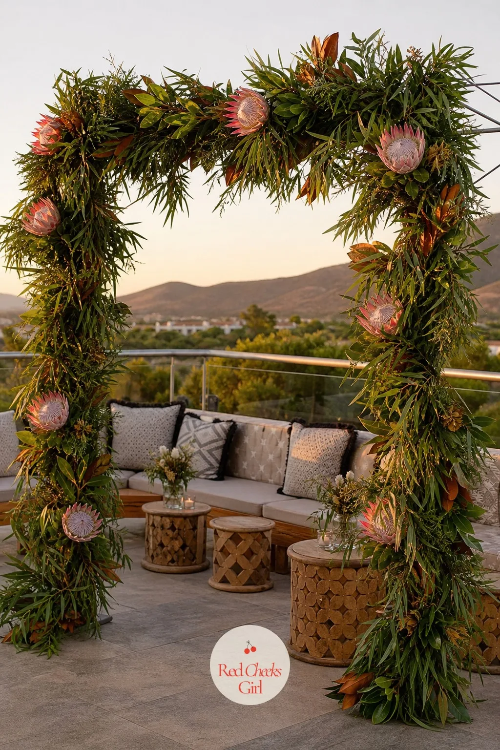 King Protea and Native Foliage Arch — She wants something that doesn't look like it came from the same florist everyone used last summer, and nothing reads