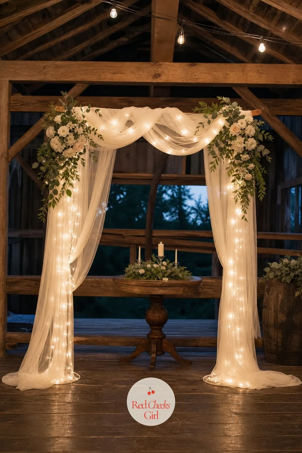 Ivory Tulle And Fairy Light Arch — This one is for an evening ceremony that needs to glow once the sun goes down, without the cost or weight of fresh flowers.