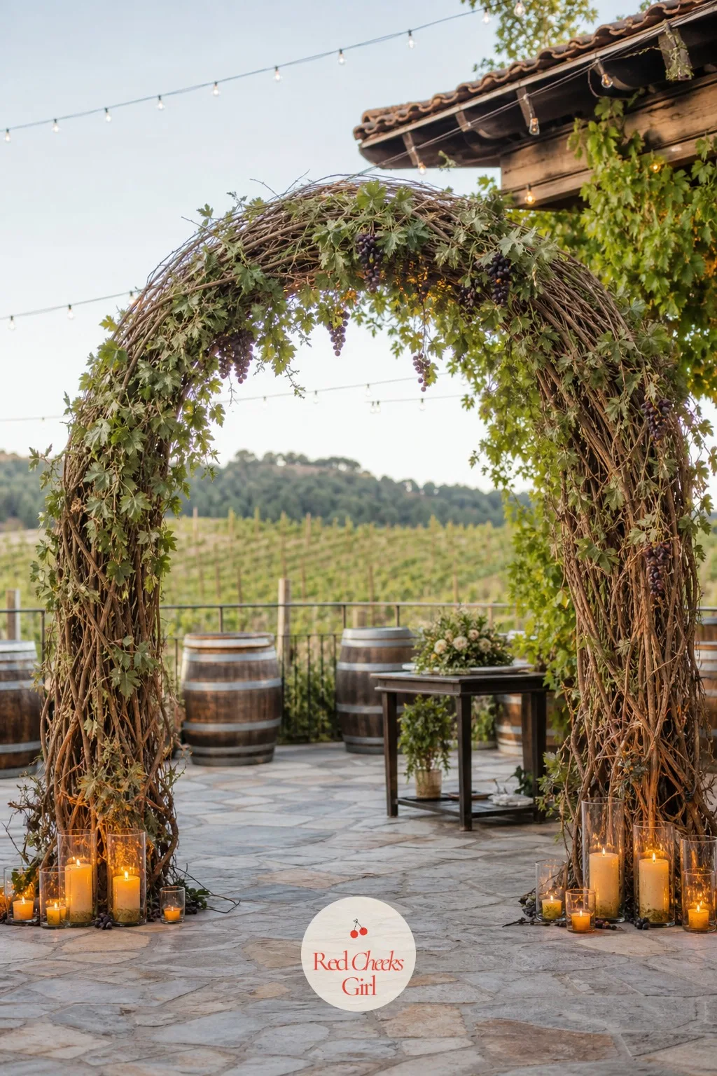 Vineyard Arch With Grapevines and Candles — A vineyard already looks like a wedding before you add anything, this arch simply echoes what is growing around it