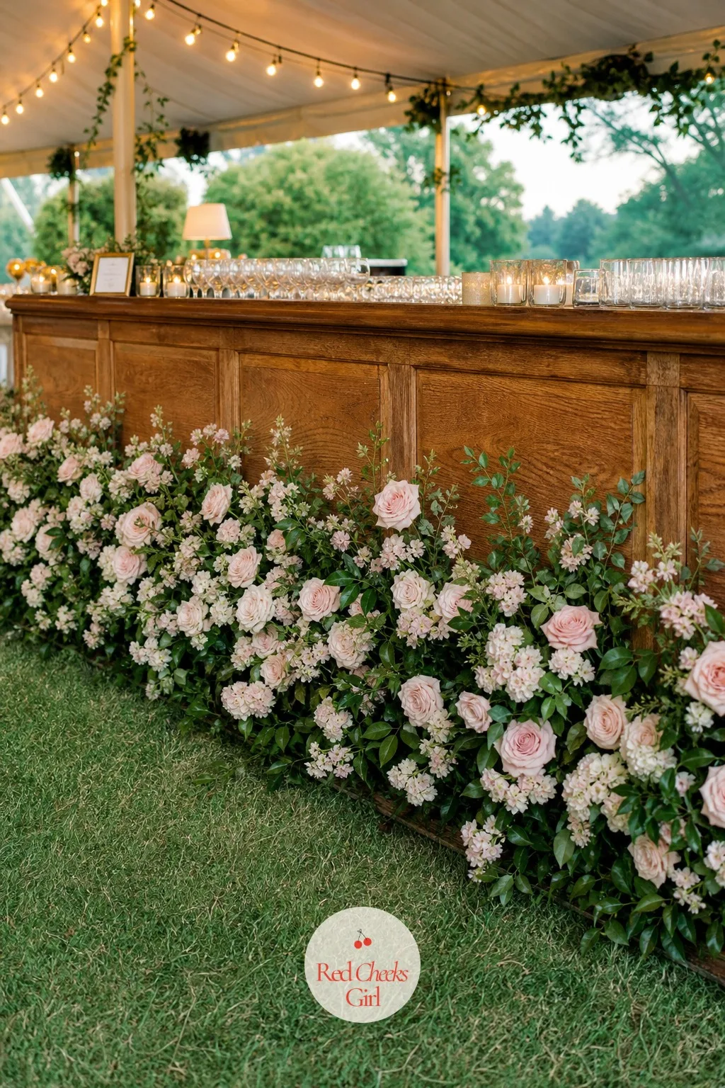 Floral Installation on the Bar Front — A bare bar front under a marquee always looks like it is still waiting for something, and this is the fix that makes it