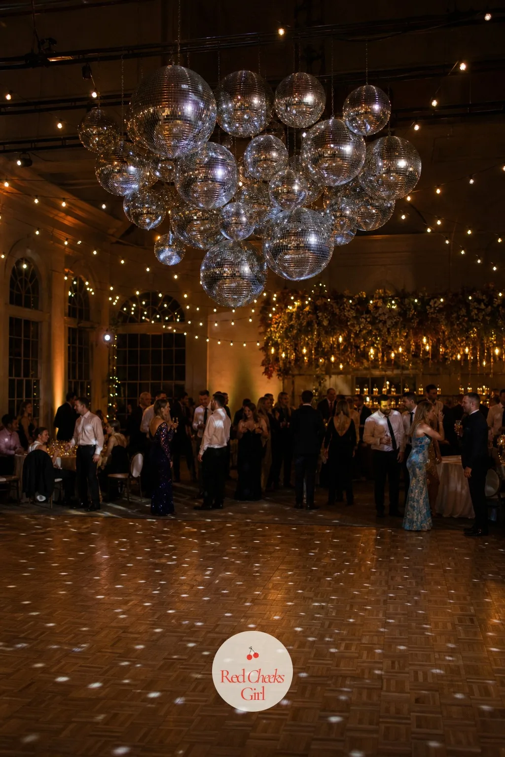 Disco Ball Cluster Over the Dance Floor — Not every reception wants to feel like a garden all night, and the dance floor is the one place allowed to break from