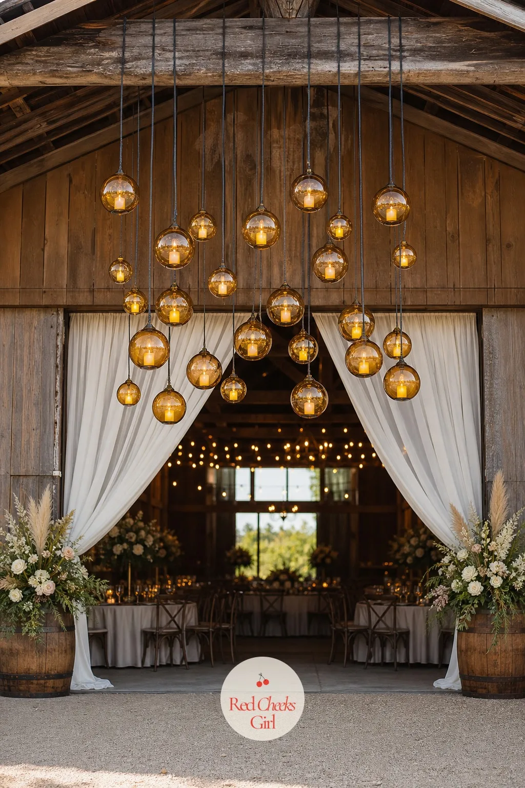 Hanging Amber Glass Orb Chandelier Over a Barn Entrance — Above a barn door, a cluster of amber glass orbs hung at different heights throws warm gold light
