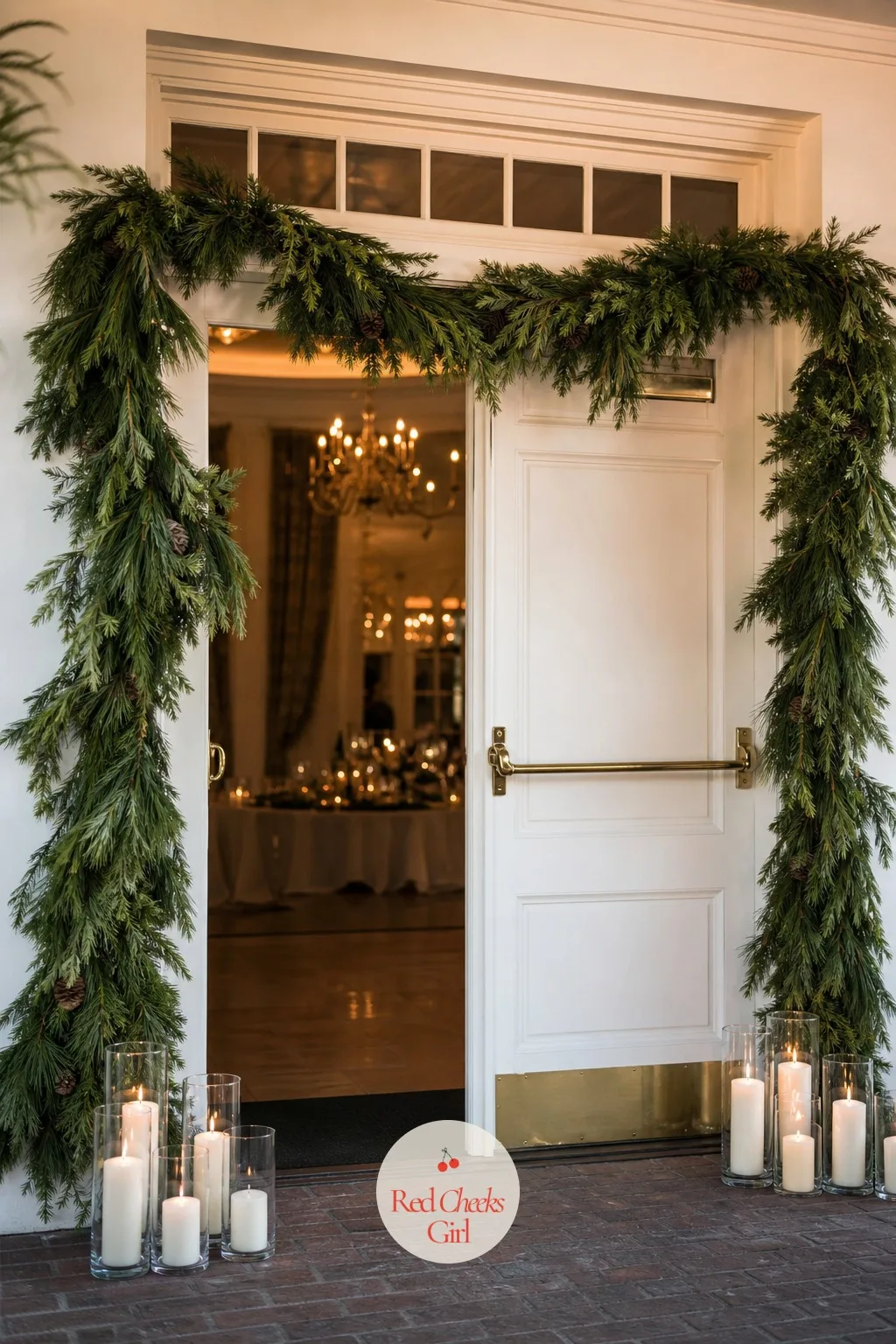 Pine Boughs and Candles at the Door — Fresh pine swagged across the top of the doorway with white candles glowing either side turns a winter entrance warm