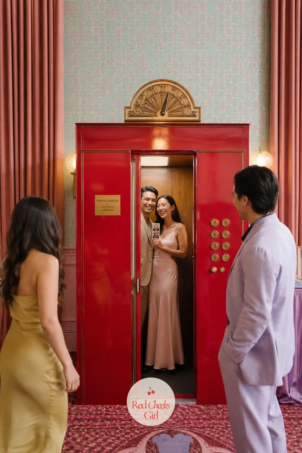 Red Elevator-Style Photo Booth — A flimsy paper backdrop never reads as a hotel, and this is the one booth that has to look built rather than printed. Wes