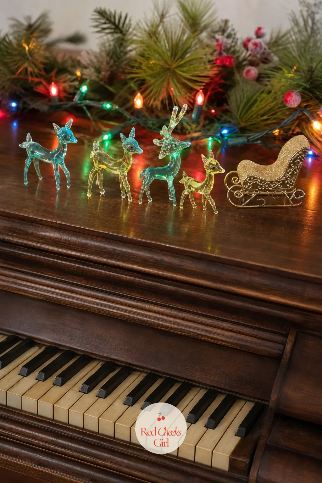 The Piano Top — Rather than the usual single arrangement, the piano top gets a parade: a line of small glass animals in aqua and lemon glass, walking toward a