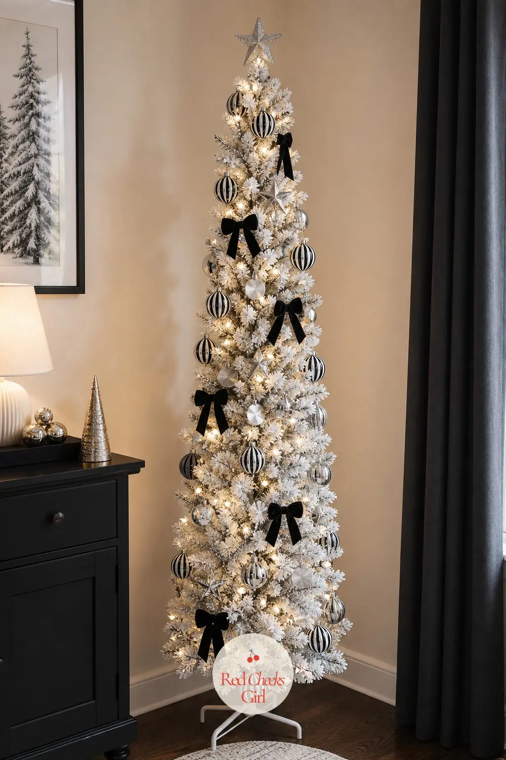 A Space-Saving Pencil Tree in Black and Silver — A slim artificial tree in the corner of a small flat, striped baubles and silver discs giving it a graphic