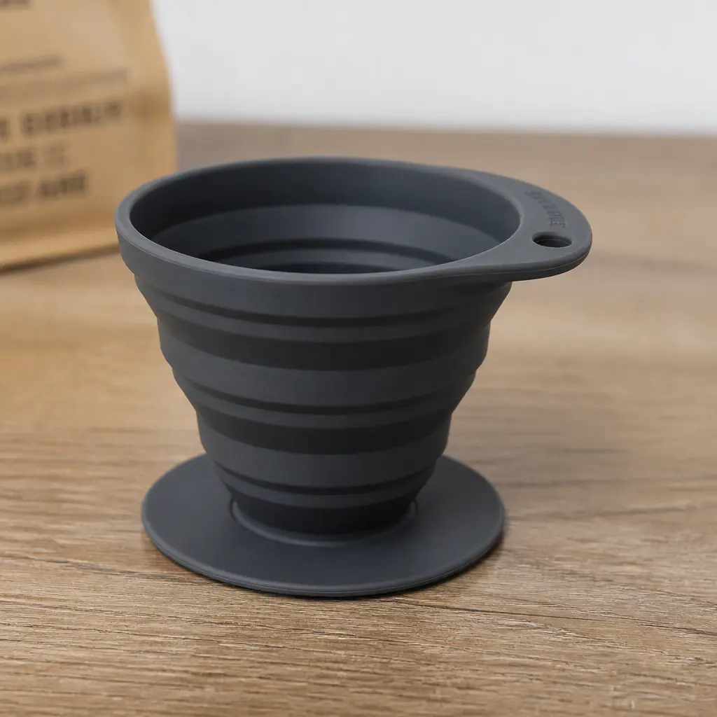 Collapsible Travel Coffee Dripper — Folds flat into a bag for the person who can't start a morning without good coffee and refuses to trust a hotel machine.