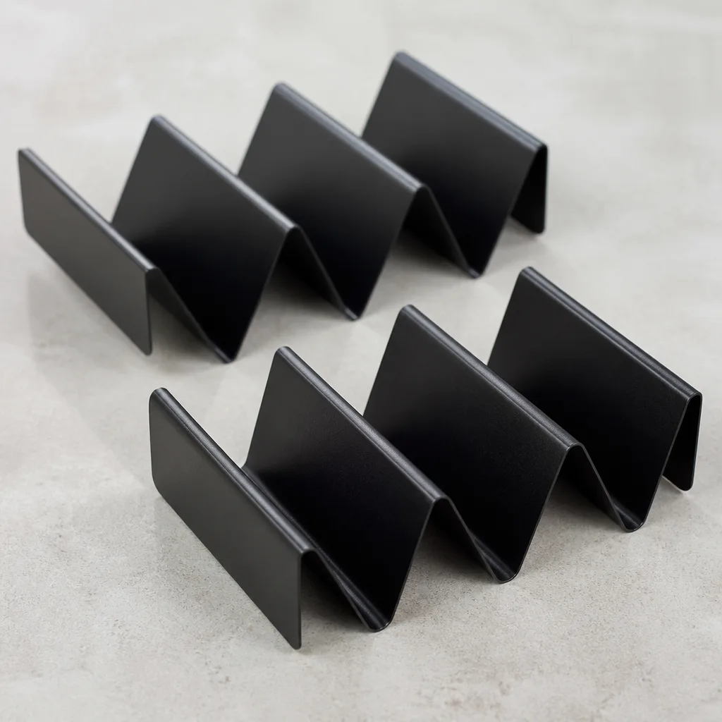 Taco Holder Stand Set — Solves the actual problem of a taco falling apart halfway through dinner, dressed up as a silly kitchen gadget. White elephant gift