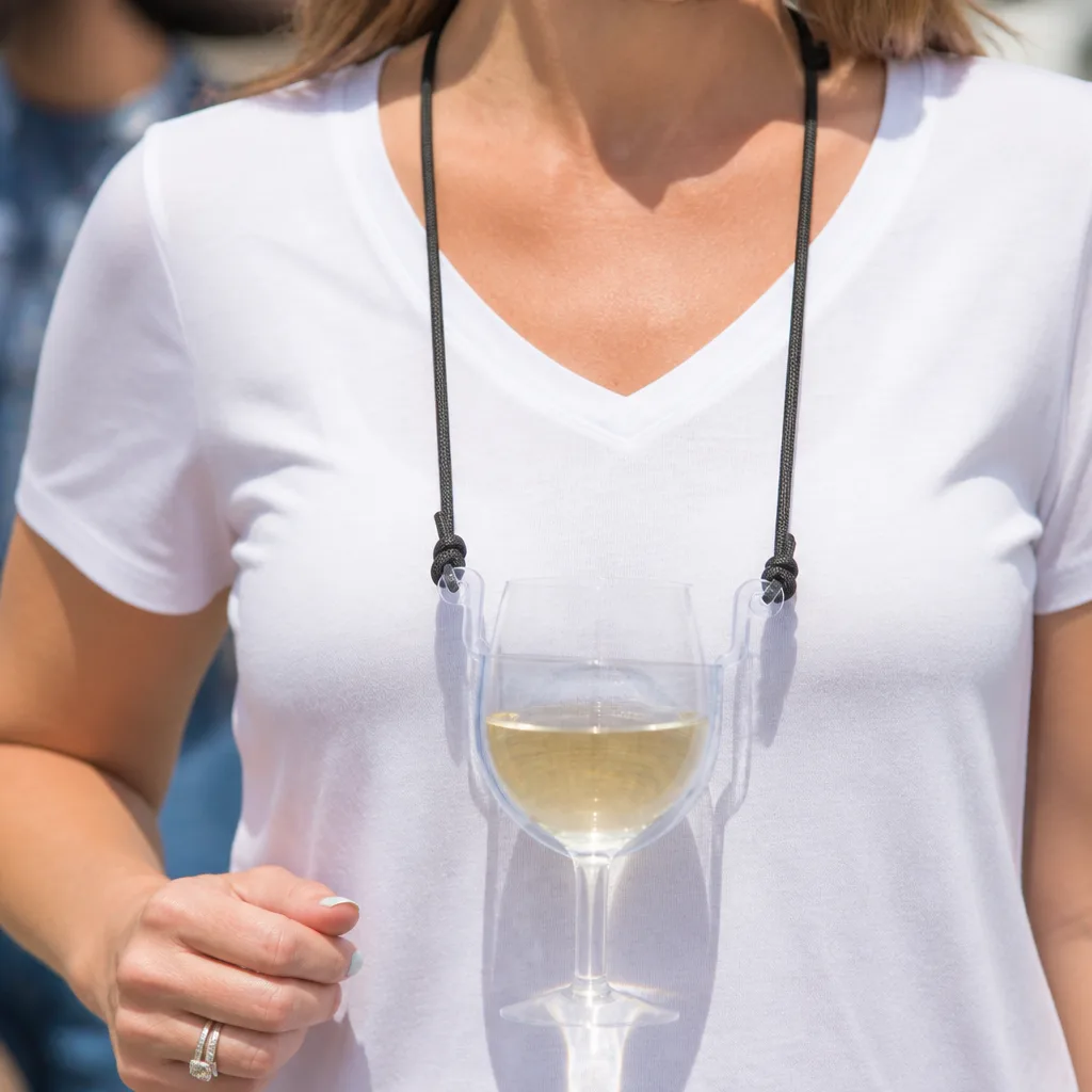 Wine Glass Holder Necklace — A wine glass on a cord around the neck, which sounds absurd until she realizes she'll never set her drink down and lose it at a