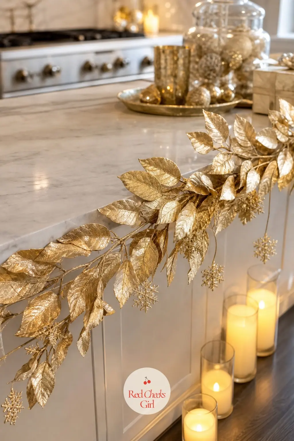 The Kitchen Island, Dressed with a Garland of Gold Leaves — A garland of gold leafed foliage along the island edge does for the kitchen what the mantel does