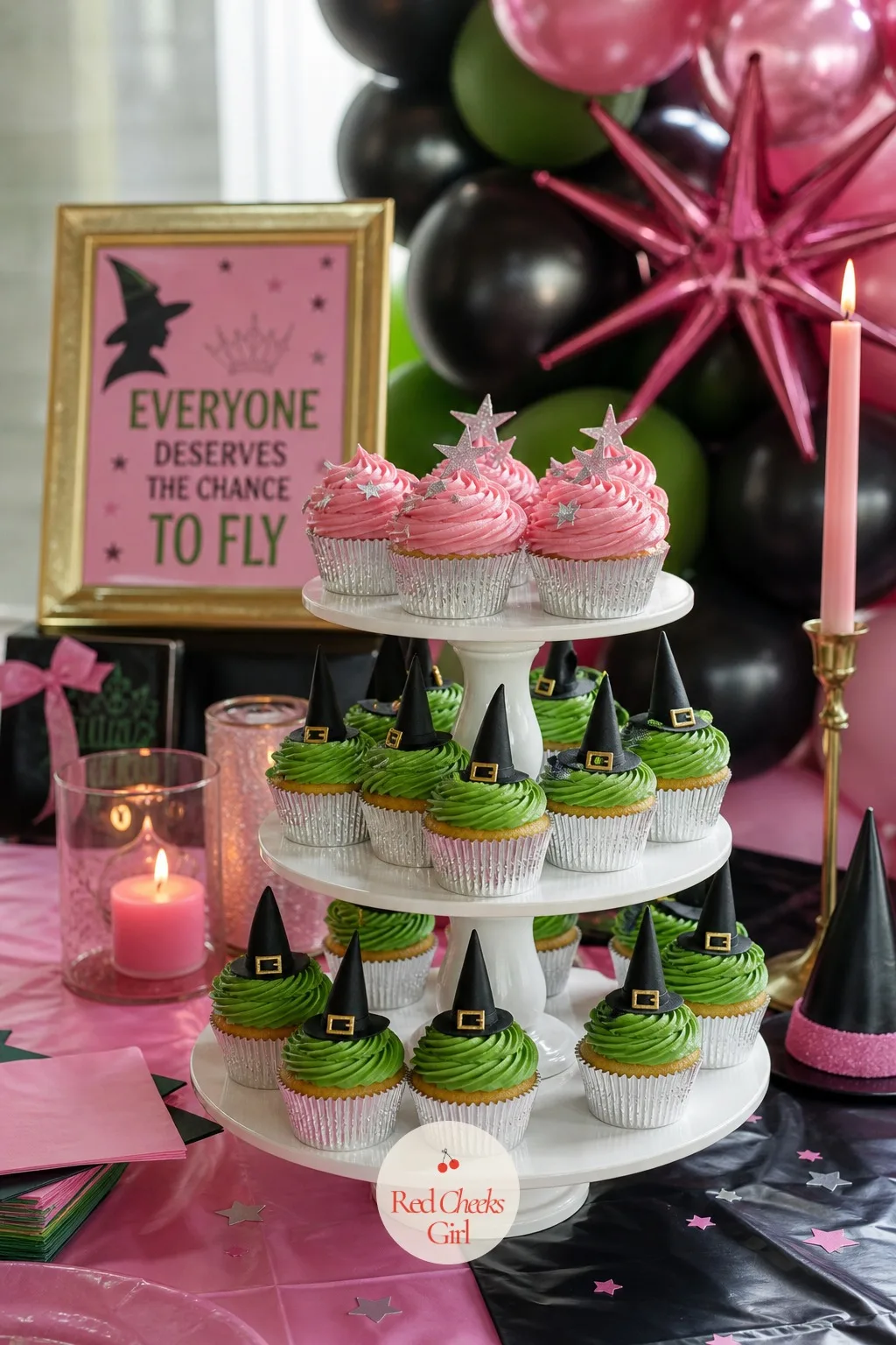 Witch Hat and Glinda Pink Cupcake Tower — A single tray of identical cupcakes undersells the Glinda and Elphaba split the whole party is built on. Wicked party