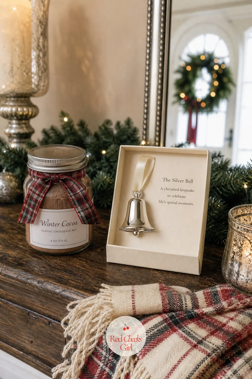 The Silver Bell Keepsake — Alongside the cocoa, one small object carries the whole weekend's motif home on its own: a single polished silver bell ornament, the