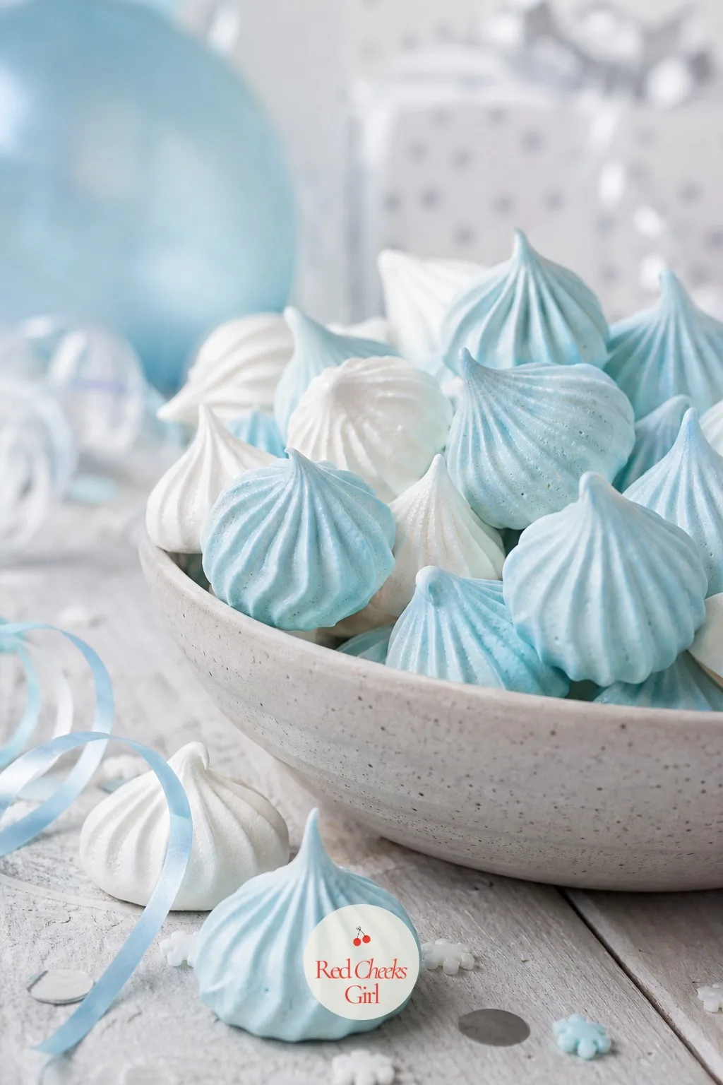 Pale Blue Meringue Snowdrift Kisses — Piped meringue kisses, tinted pale blue at the base and fading to white at the tip, piled loose in a bowl, look exactly