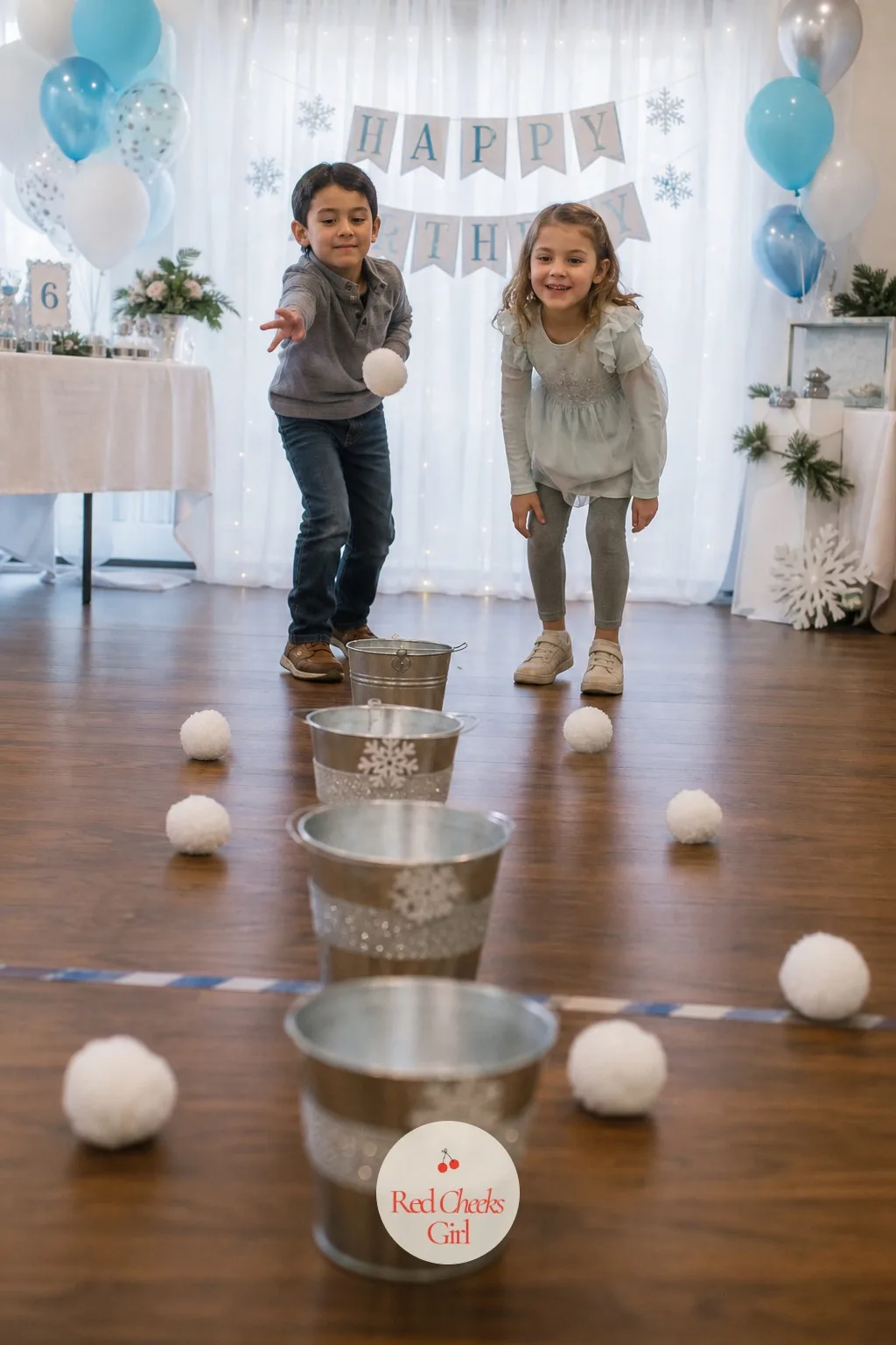Snowball Toss Into Buckets — White yarn pom-poms stand in for snowballs here, soft enough to toss indoors without anyone flinching. Winter birthday party ideas