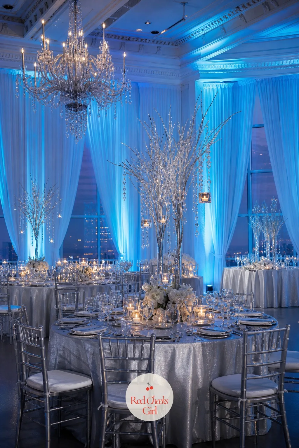 Icy Blue Uplighting — Overhead lighting alone leaves a white room looking flat once the sun goes down, which is exactly the moment the venue needs to look its