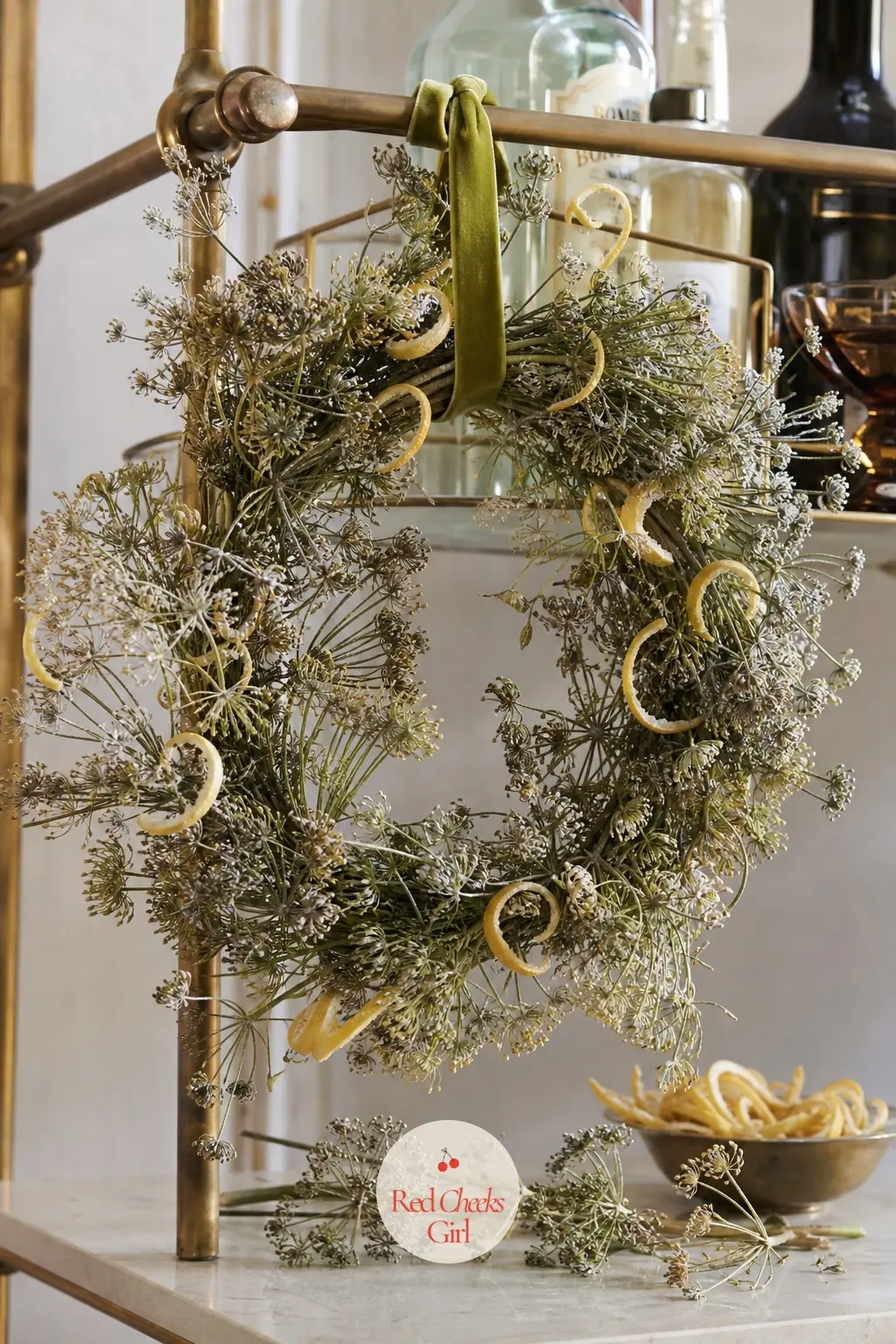 A Frosted Dill and Lemon Zest Snipping Wreath by the Bar — Feathery dried dill fronds woven through curls of dried lemon zest hang within reach of the bar so