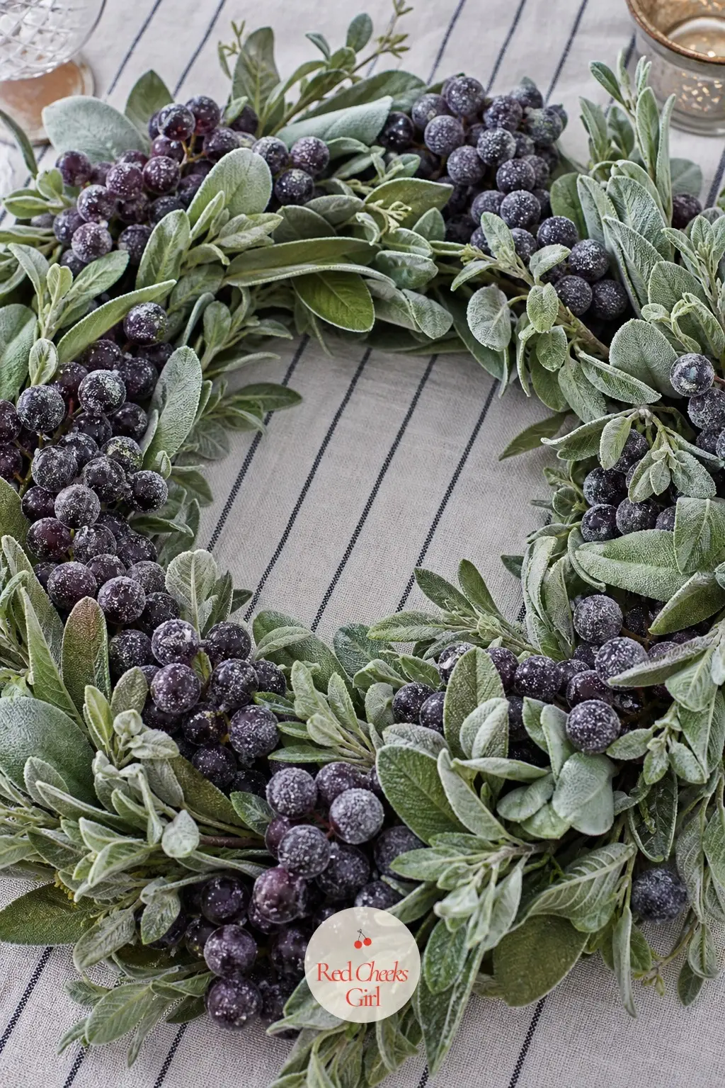 Frosted Grape and Sage Leaf Table Wreath — Faux grape clusters dipped in a frosted finish sit among soft sage green leaves for a low table wreath that